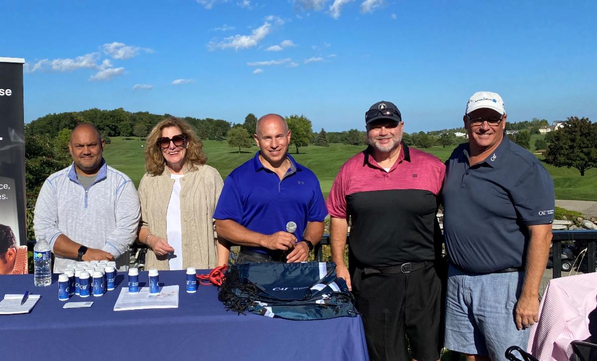 Exhibitor and event leaders posing at the Golf Event sponsored by Rockwell Automation and Disability:IN Wisconsin